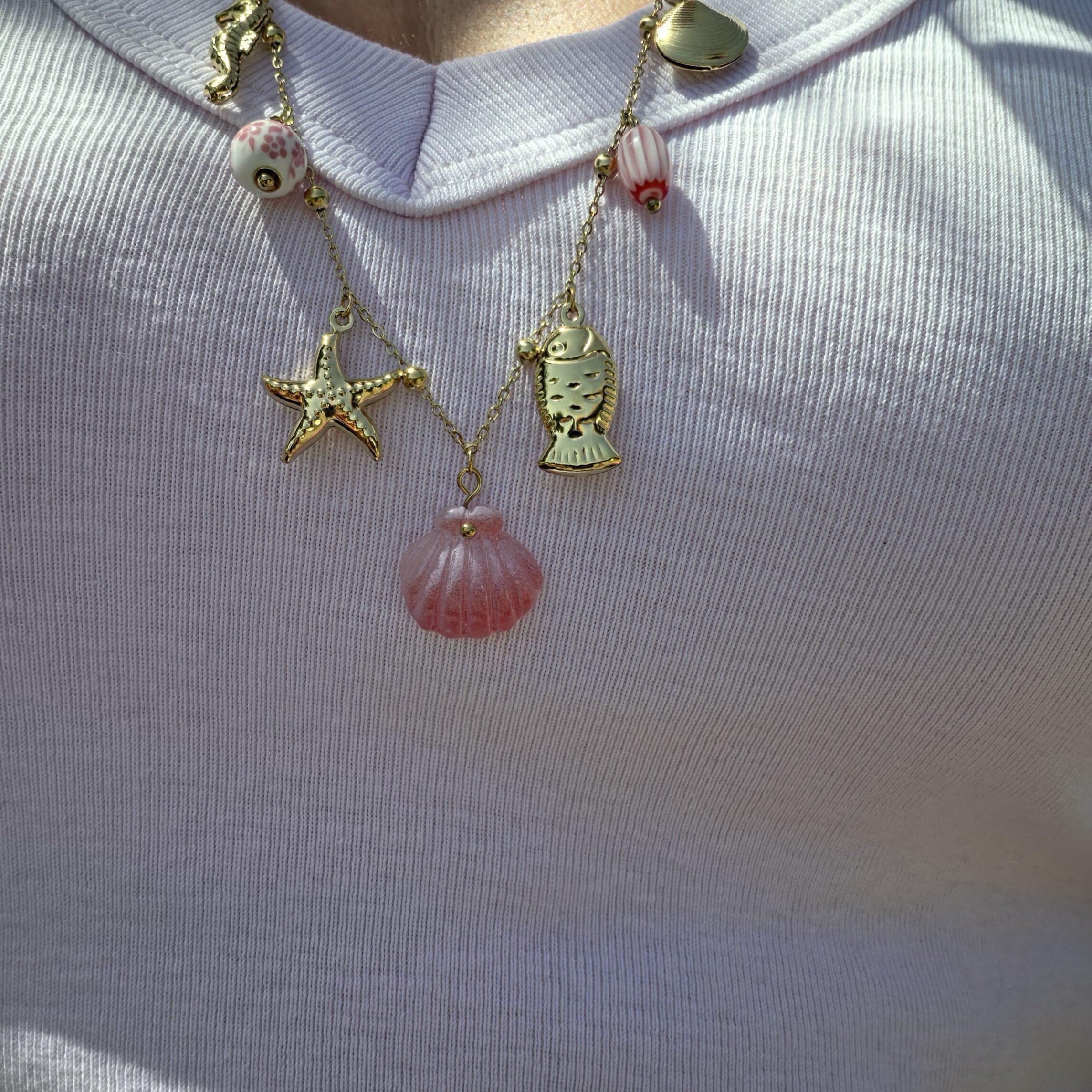 Collier Brigitte porté couleur or en acier inoxydable avec diverses breloques thème mer, coquillage, poisson... By Créa'Lise en Vendée!
